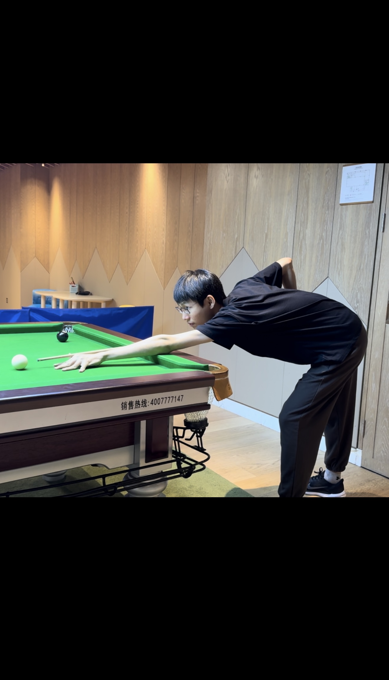 Taking a shot at a billiards table