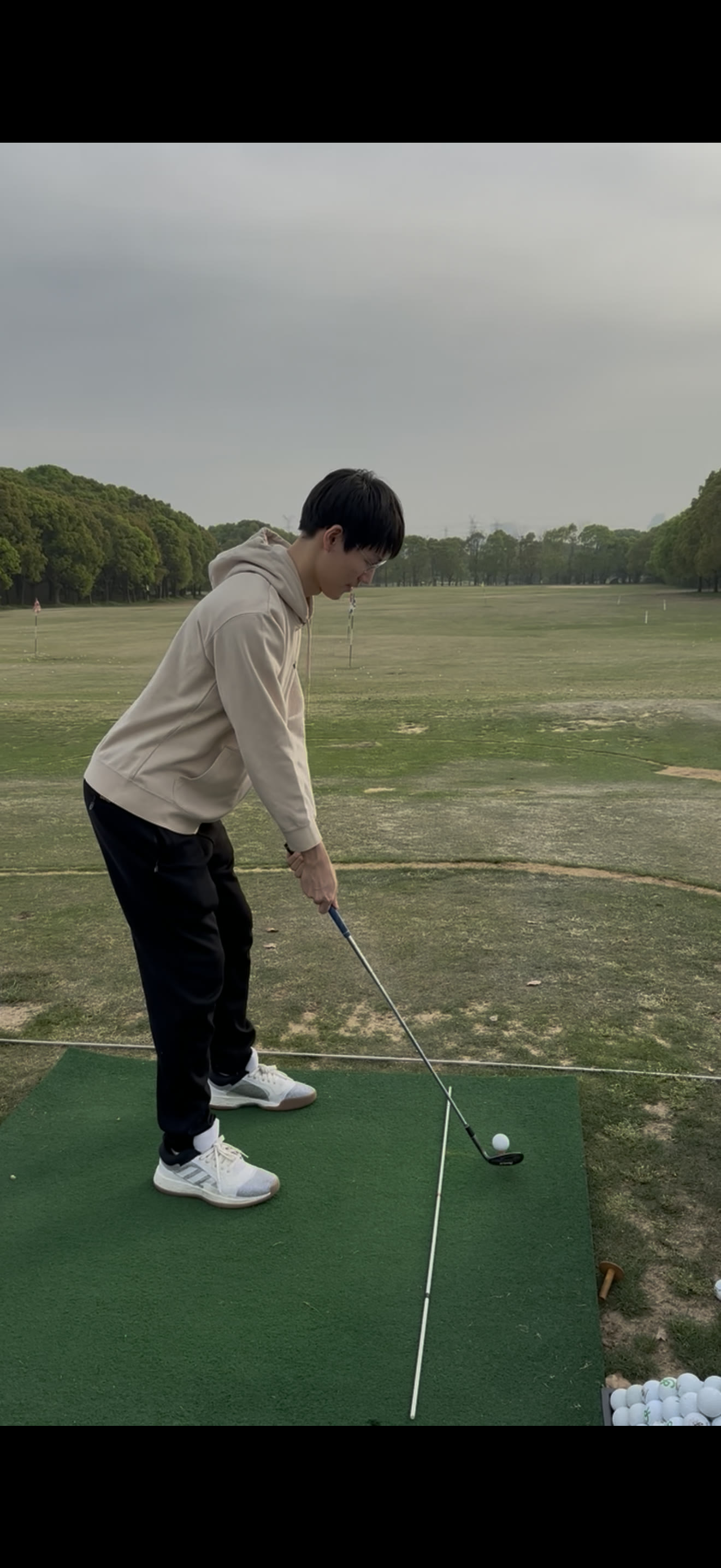Practicing a golf shot at a driving range